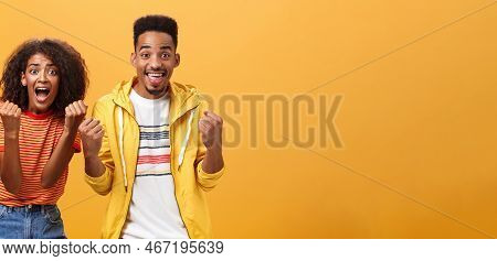 Two Friends Cheering And Supporting Mate On Competition Yelling Joyfully Clenching Fists In Supporti