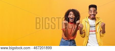 Two Friends Cheering And Supporting Mate On Competition Yelling Joyfully Clenching Fists In Supporti