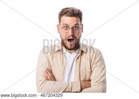 Shoked Caucasian Male On White Background With Hands Crossed On The Chest Looking To Camera