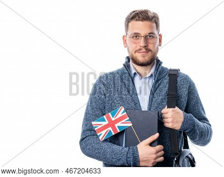 Handsome Caucasian Male In Eyeglasses Holding Britis Flag And Looking To Camera