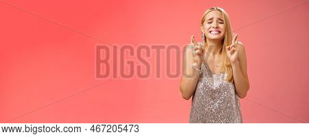 Nervous Hopeful Blond Young Woman In Silver Trendy Dress Close Eyes Grimacing Eager Wish Come True C
