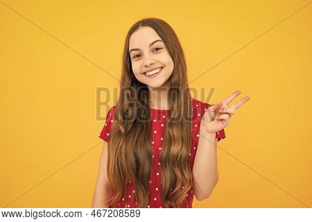 Cheaky Teen Girl Giving Victory Sign. Happy Teenager Child Smiling With V-sign, Positive Gesture, St