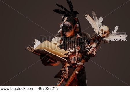 Necromancer Reading Book Of Dead Against Gray Background