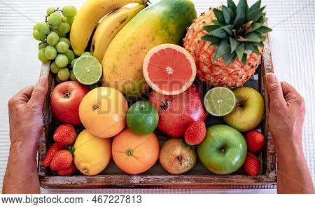Close-up On A Wooden Basket Full Of Colorful Fresh Fruit.  Healthy Nutrition And Lifestyle Concept.