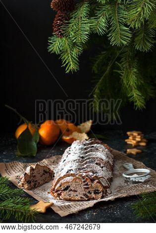 Christmas Stollen On A Dark Background. Traditional German Christmas Dessert, Cut Into Pieces. Cake 