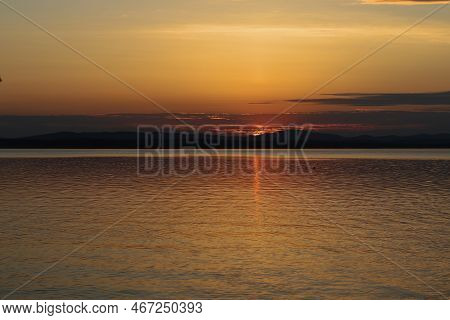 Picturesque View From The Shore Of Lake Uvildy To The Evening Summer Sunset. The Photo Was Taken On 