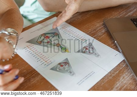 Tver, Russia - August 2, 2021. A Woman In A Cafe At A Table Is Studying The Design Of A Person. The 