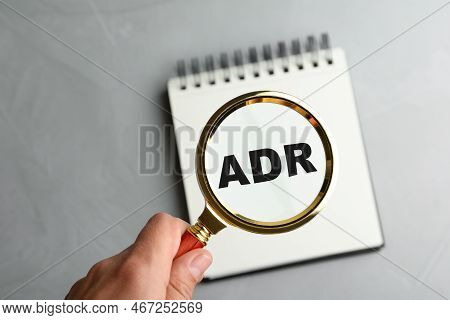 Alternative Dispute Resolution. Closeup Of Woman Holding Magnifier Glass Over Abbreviation Adr In No