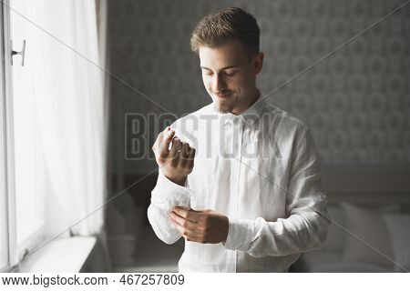 Grooms Morning Preparation. Handsome Man Getting Dressed And Preparing For The Wedding