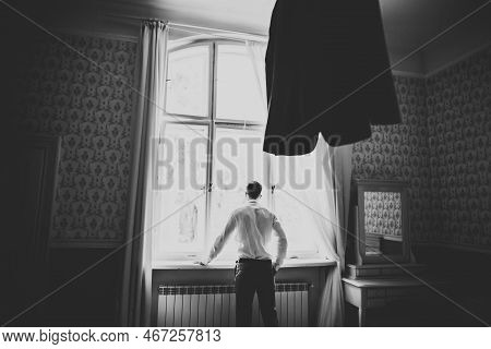 Grooms Morning Preparation. Handsome Man Getting Dressed And Preparing For The Wedding