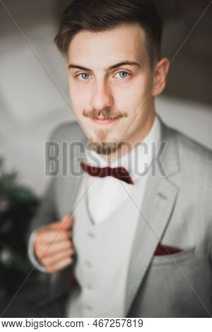 Grooms Morning Preparation. Handsome Man Getting Dressed And Preparing For The Wedding