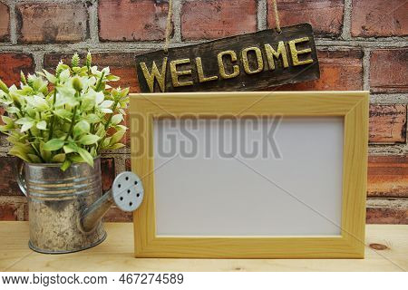 Empty Photo Frame Mock Up With Welcome Sign And Artficial Plant Home Decoration