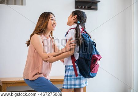 Loving Mother And Schoolgirl With Backpack Before First Day, Asian Mother Hugging Her Daughter Sayin