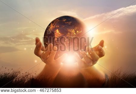 Earth At Night Was Holding In Human Hands. Earth Day. Energy Saving Concept, Elements Of This Image 