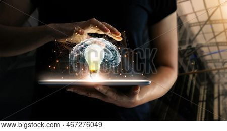 Human Holding Tablet With Light Bulb Future Technology, Brain And Network Connection Communication B