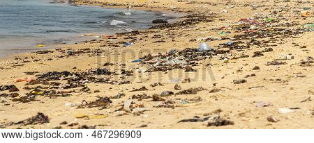 Warang, Mbour, Senegal - Circa January 20222. Beach Sand Of Atlantic Ocean With So Many Garbage Plas