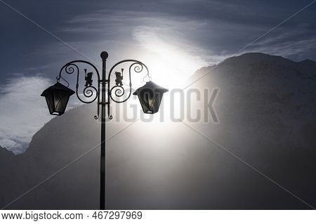 A Backlit Street Lamp In A Winter Alpine Landscape