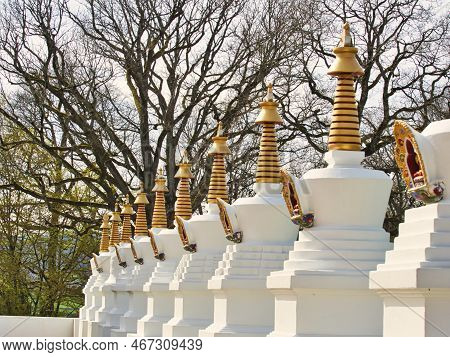 La Boulaye, France - April Circa, 2018. Several Small White Stupas With Traditional Eyes Of Buddha P