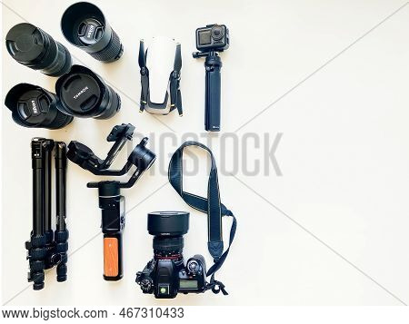 Usa - 2022: Flat Lay Composition With Equipment For Professional Photographer On White Table Backgro