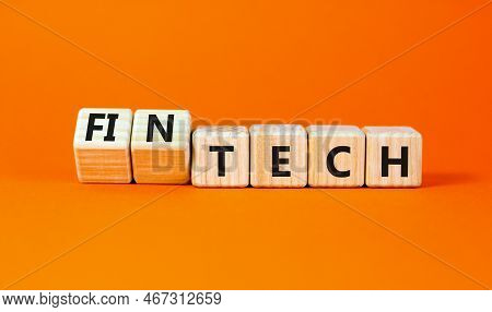 Tech Or Fintech Symbol. Concept Word Tech And Fintech On Wooden Cubes. Beautiful Orange Table Orange