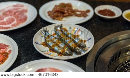 Shishamo Fish In Dish For Barbecue. Japanese Smelt Fish