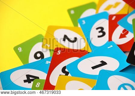 Ternopil, Ukraine - May 15, 2022: Many Colorful Uno Game Cards On Yellow Background Close Up. Uno Is
