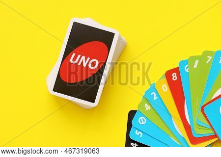 Ternopil, Ukraine - May 15, 2022: Many Colorful Uno Game Cards On Yellow Background Close Up. Uno Is