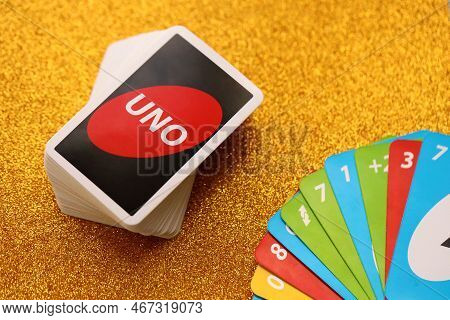 Ternopil, Ukraine - May 15, 2022: Many Colorful Uno Game Cards On Golden Background Close Up. Uno Is