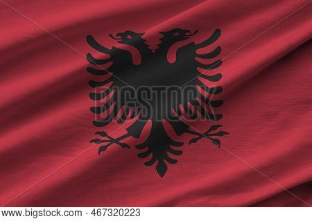 Albania Flag With Big Folds Waving Close Up Under The Studio Light Indoors. The Official Symbols And