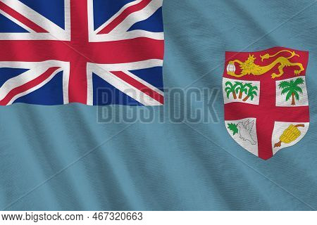 Fiji Flag With Big Folds Waving Close Up Under The Studio Light Indoors. The Official Symbols And Co