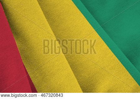 Guinea Flag With Big Folds Waving Close Up Under The Studio Light Indoors. The Official Symbols And 