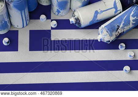 Greece Flag And Few Used Aerosol Spray Cans For Graffiti Painting. Street Art Culture Concept, Vanda