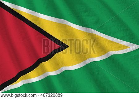 Guyana Flag With Big Folds Waving Close Up Under The Studio Light Indoors. The Official Symbols And 