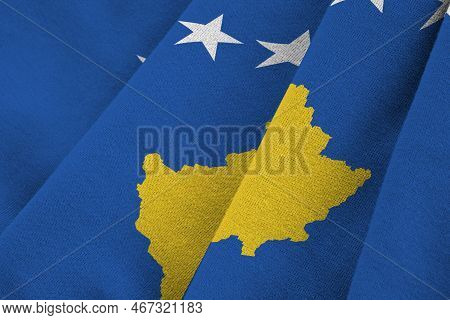 Kosovo Flag With Big Folds Waving Close Up Under The Studio Light Indoors. The Official Symbols And 