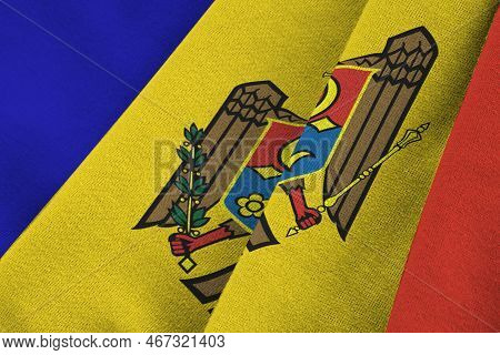 Moldova Flag With Big Folds Waving Close Up Under The Studio Light Indoors. The Official Symbols And