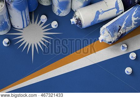 Marshall Islands Flag And Few Used Aerosol Spray Cans For Graffiti Painting. Street Art Culture Conc