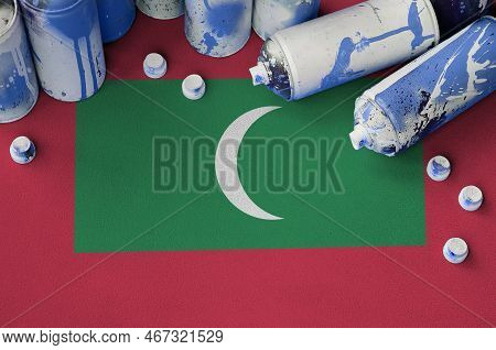 Maldives Flag And Few Used Aerosol Spray Cans For Graffiti Painting. Street Art Culture Concept, Van