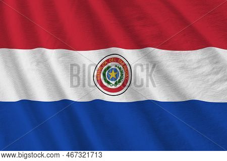 Paraguay Flag With Big Folds Waving Close Up Under The Studio Light Indoors. The Official Symbols An