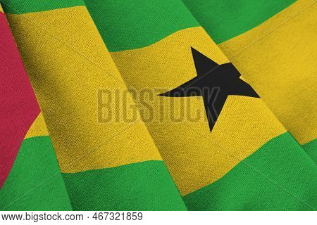 Sao Tome And Principe Flag With Big Folds Waving Close Up Under The Studio Light Indoors. The Offici