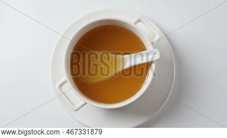 Chicken Bone Broth In A White Soup Bowl
