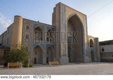 Bukhara, Uzbekistan - September 09, 2022: Facade Of Medieval  Mirzo Ulugbek Madrasah On A Sunny Sept