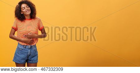 Mmm Delicious Meal Warming Me Inside. Delighted Stuffed Good-looking Stylish Young Female In Striped