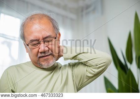 Close Up Of Sad Senior Man Neckache Hand Holding Neck, Old Man Suffering From Nape Neck Pain At Home