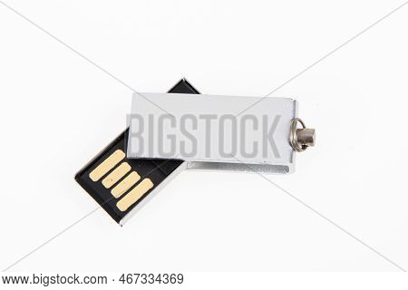 Metal Silver Usb Flash Drive Rotative System Connected On White Desk Background