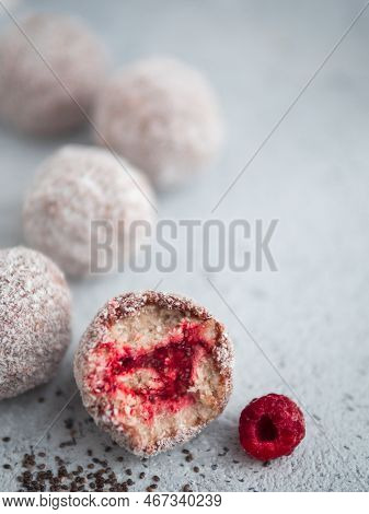 Raw Vegan Lamington Bliss Balls With Raspberries Chia Jam On Gray Background. No Baked Healthy Vegan