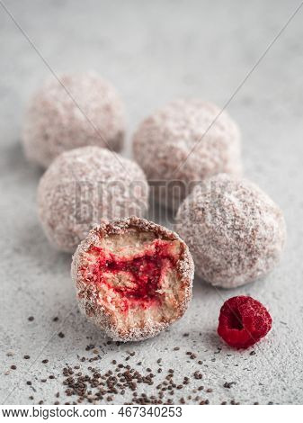 Raw Vegan Lamington Bliss Balls With Raspberries Chia Jam On Gray Background. No Baked Healthy Vegan