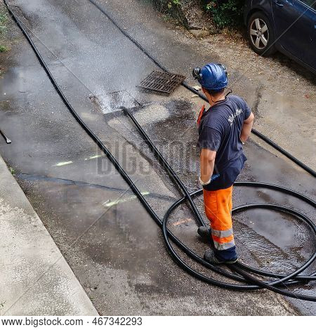 Menthon Saint Bernard, France - September 09 2021: A Professional Worker Is Busy With A Pump Car And