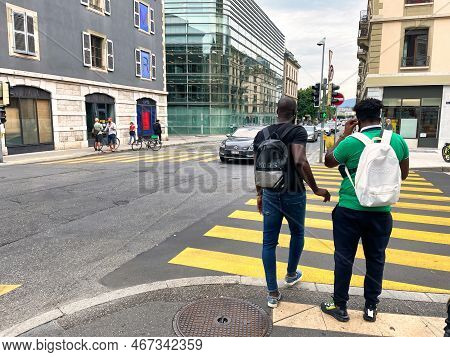 Geneva, Switzerland - September 14 2021: Two African American Persons Walking On A Sidewalk In The C