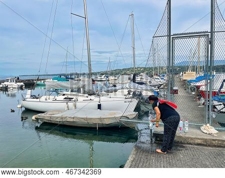 Geneva, Switzerland - September 14 2021: Luxurious And Expensive Yachts Are Docked In A Harbor On La