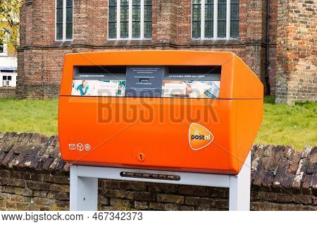 Voorburg, Netherlands - May 04 2021: A Mail Box For Post In The Netherlands Is Orange And Can Be Fou